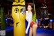 A woman standing next to a punching bag in a gym.