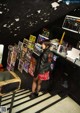 A woman standing on a set of stairs in a room.