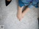 A woman's bare feet on a tiled floor. 