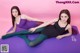 A couple of women laying on top of a purple mat.