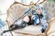 A woman with blue hair is sitting on a couch.