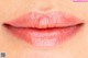 a close up of a woman's lips with a pink lipstick