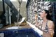 A woman in a bikini blowing bubbles in a pool.