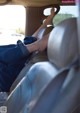 A person sitting in the back seat of a car with their feet up.