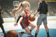 A girl dribbling a basketball on a basketball court.